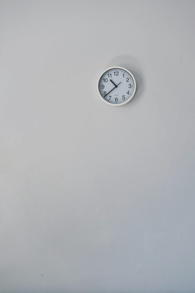 A clock on a white wall.