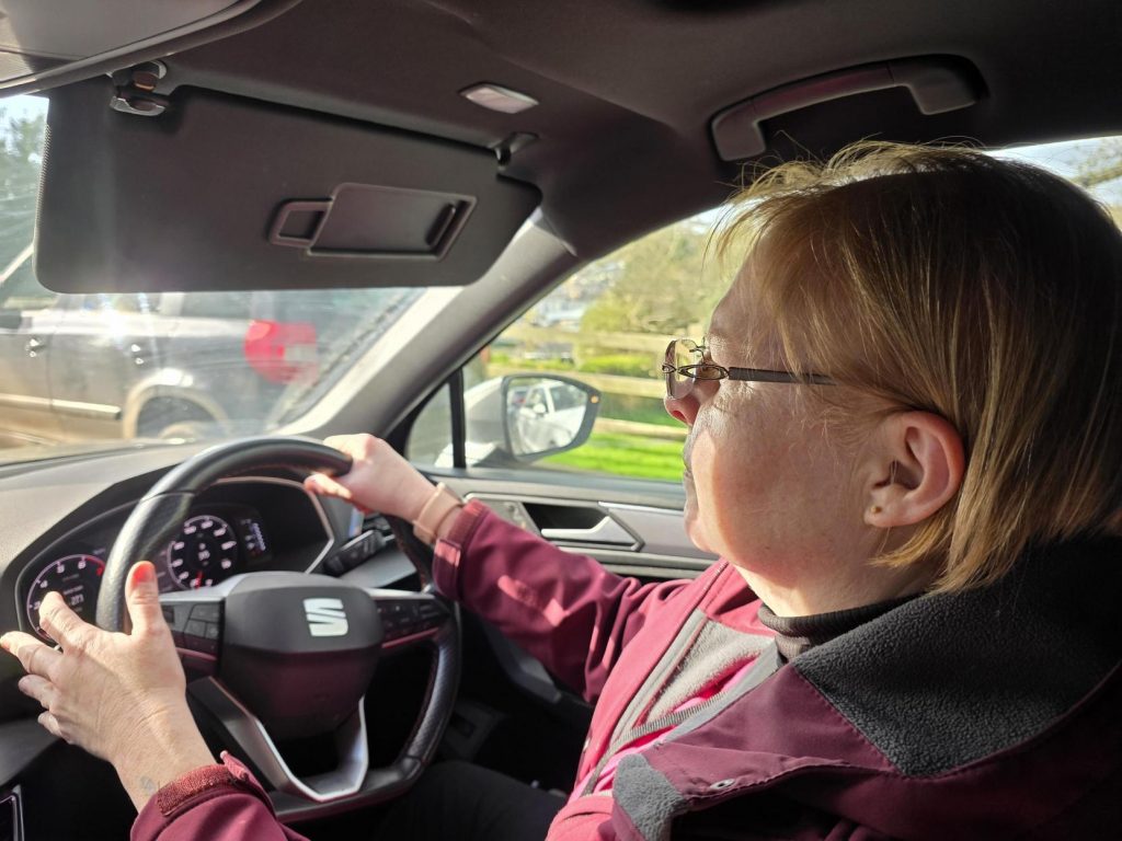 A carer driving a car