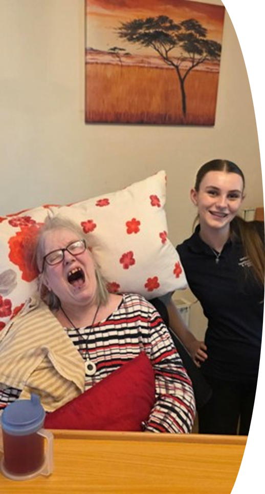 A person laughing with Esme, a work placement student at Teign Angels